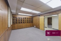 Office interior with wood paneling and built-in shelving
