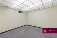 Empty office room with carpet and drop ceiling lights