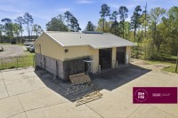 Warehouse building with large garage doors and concrete lot