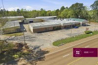 Commercial property along highway with parking and main building